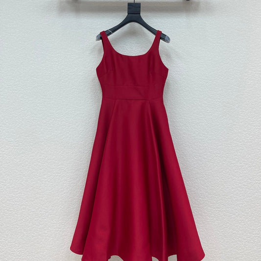 Red dress hanging on a black hanger against a white wall