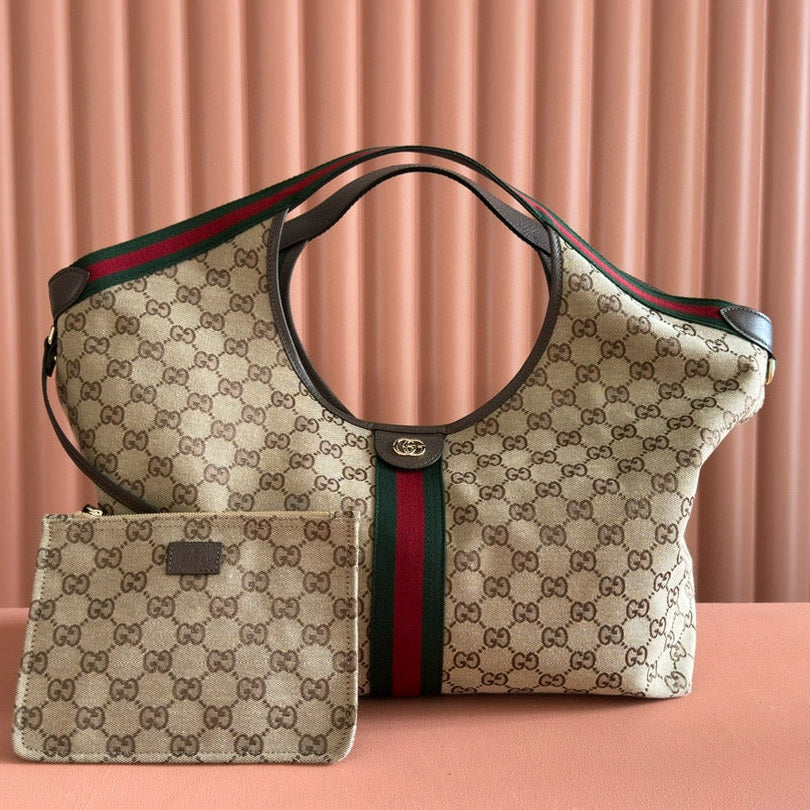 Designer handbag with matching pouch on a pink background