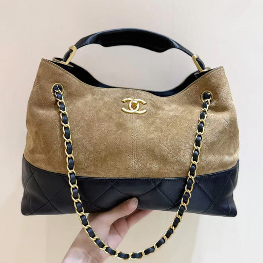 Chanel handbag with gold chain and logo on a beige background