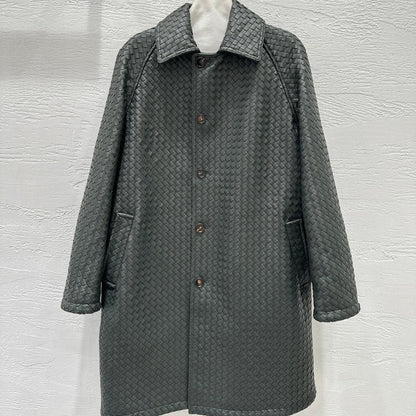 Gray textured coat hanging on a rack against a white wall